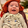 Pierre participe au concours pour gagner de l'argent avec cette photo : apparel, baby, blurred_background, bunny_print, child, closeup, cute, expression, face, happy, headwear, indoor, infant, joyful, onesie, orange_cloth, person, portrait, smiling, warm_lighting