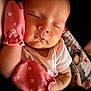 Autumn is registered to the contest to win money with this photo: baby, sleeping, mittens, pink, infant, closeup, peaceful, soft_light, tattoo, arm, skin, face, child, newborn, cute, apparel, resting, human, portrait, comfort