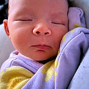 Autumn is registered to the contest to win money with this photo: baby, sleeping, close_up, infant, soft_fabric, purple_clothing, yellow_pattern, peaceful, face, skin, newborn, child, cute, resting, portrait, cozy, indoors, young, nap, comfort