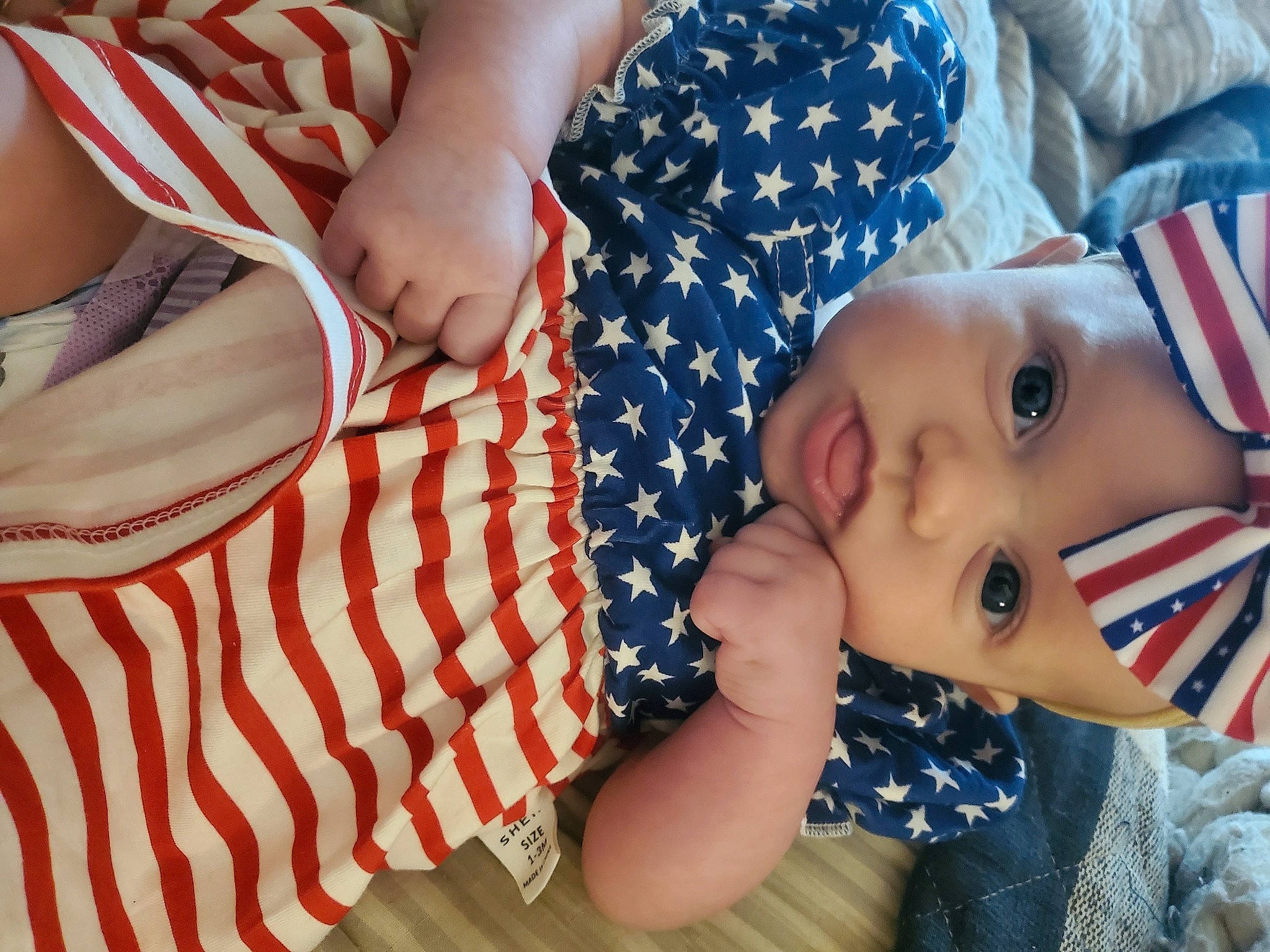 Lilliana joined the competition — help win amazing prizes! baby, baby_toddler_clothing, child, comfort, elbow, flag_of_the_united_states, fun, gesture, grass, happy, hat, headwear, human_body, linens, nail, pattern, person, sitting, sleeve, textile