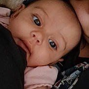Lucille is registered to the contest to win money with this photo: adult, affection, baby, child, closeup, comfort, cuddle, expression, eye, face, family, head, human, indoor, infant, love, person, portrait, skin, soft_light