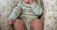 Emiliana joined the competition — help win amazing prizes! baby, bunny_pattern, child, cozy, curious_eyes, cute, indoor, infant, onesie, person, pillow, plush, portrait, relaxation, resting, sleepwear, small_feet, small_hands, soft_lighting, thumb_sucking