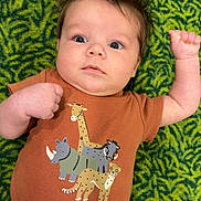 Wesson Ryan is registered to the contest to win money with this photo: baby, infant, child, green_carpet, brown_shirt, cartoon_animals, giraffe, rhino, cheetah, warthog, camo_pants, raised_arm, wide_eyes, lying_down, cute, indoor, patterned_background, casual_clothing, portrait, young_child