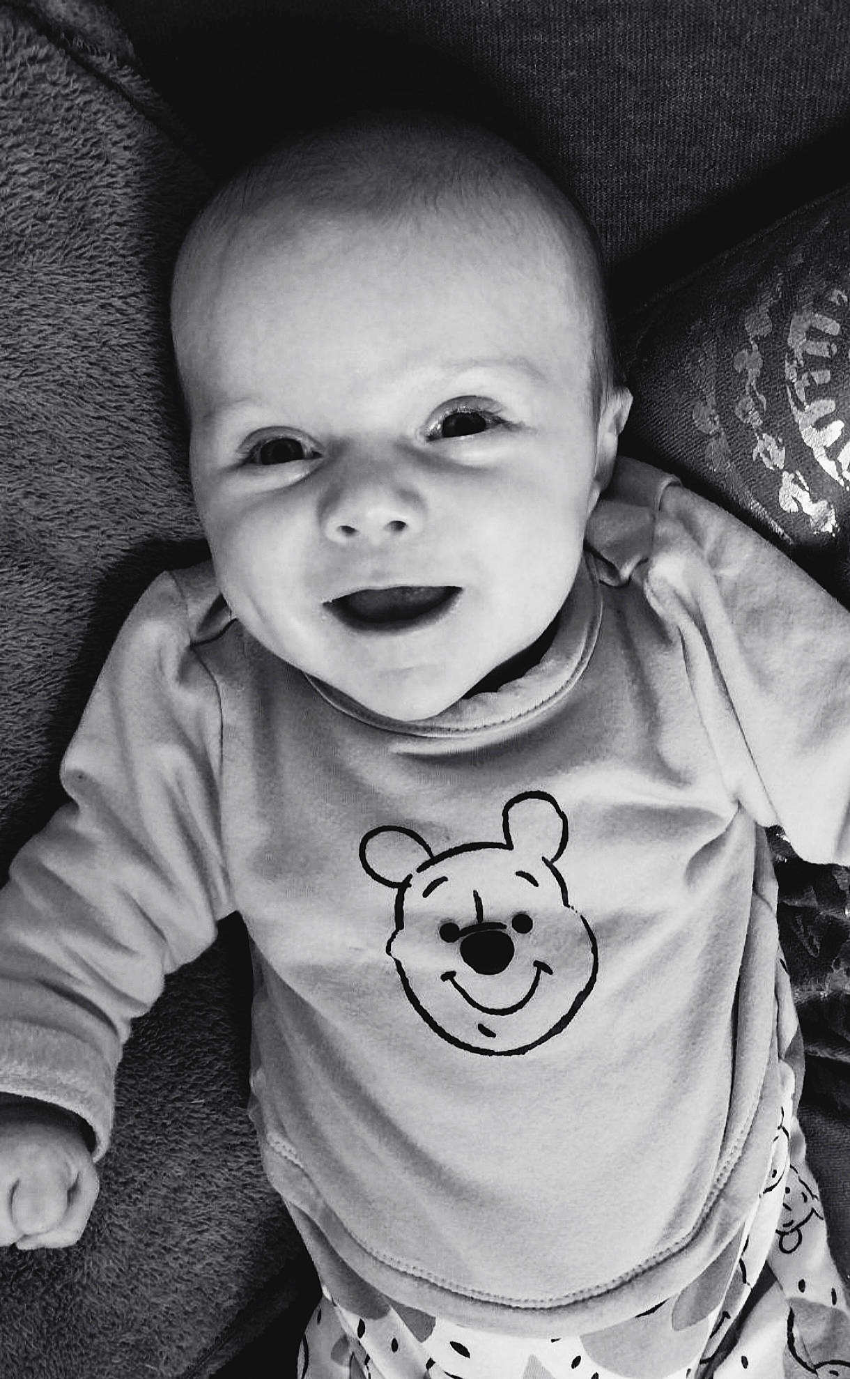 Malho participe au concours pour gagner de l'argent avec cette photo : baby, baby_toddler_clothing, black, black_and_white, cheek, cool, flash_photography, happy, human_body, iris, lip, mammal, mouth, nose, person, photograph, skin, sleeve, smile, style