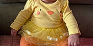 Riley-Rae is registered to the contest to win money with this photo: baby, child, smiling, toddler, yellow_clothing, orange_tights, tutu, sitting, pink_blanket, couch, happy, cute, indoors, portrait, infant, face, apparel, cozy, soft_texture, funny_outfit