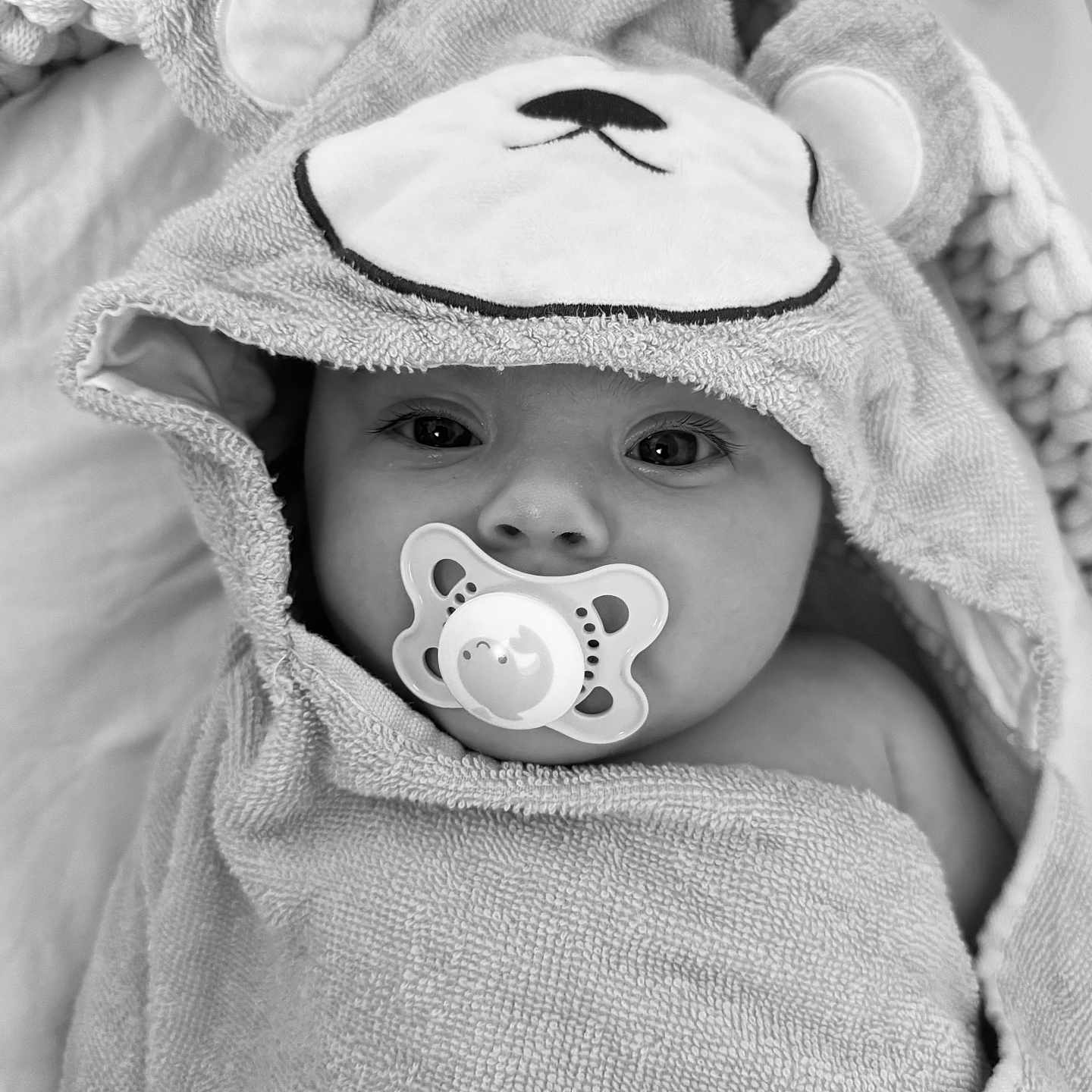 Riley-Rae joined the competition — help win amazing prizes! adorable, baby, black_and_white, blanket, child, closeup, comfort, cute, eyes, face, hood, indoors, infant, pacifier, portrait, sleepy, soft, texture, towel, wrapped
