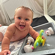 Riley-Rae joined the competition — help win amazing prizes! baby, child, smiling, blue_eyes, toy, water, duck, play, indoor, diaper, happy, face, hand, splash, tray, curtain, radiator, floor, plastic_toy, infant
