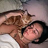 Alma participe au concours pour gagner de l'argent avec cette photo : woman, cat, bed, pillow, blanket, tattoo, bracelet, necklace, sleeping, resting, orange_cat, pet, indoor, cozy, relaxation, human, animal, face, skin, comfort
