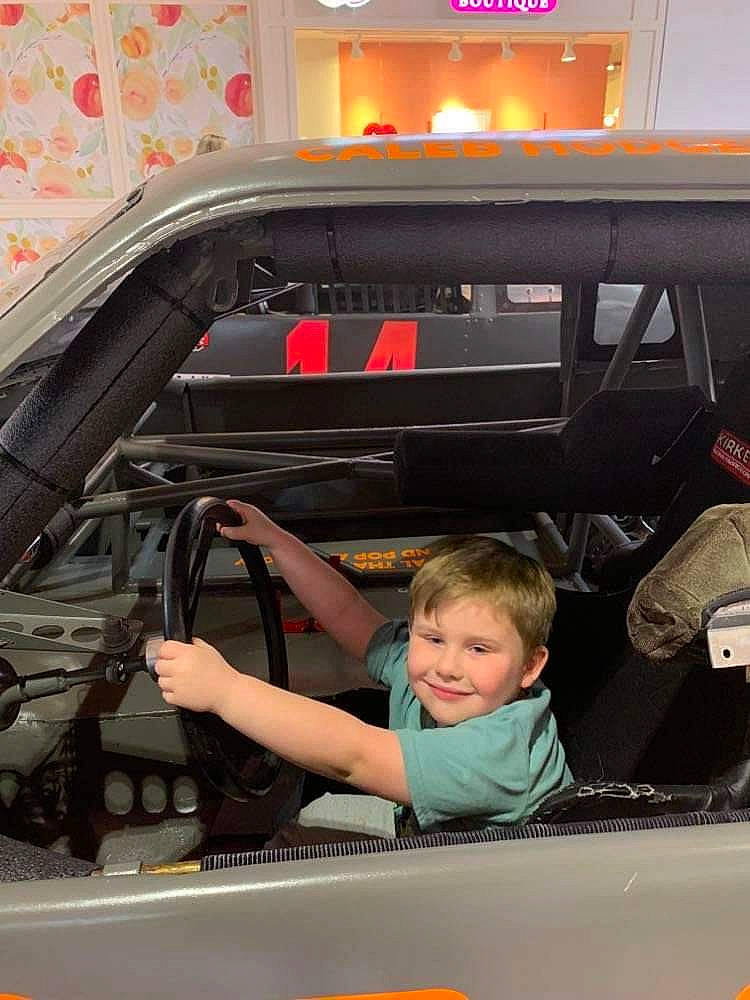 Xavier is registered to the contest to win money with this photo: auto_part, automotive_design, automotive_exterior, automotive_lighting, automotive_wheel_system, automotive_window_part, bumper, car, family_car, glass, hood, joy, motor_vehicle, person, personal_luxury_car, smile, steering_wheel, t_shirt, toddler, vehicle