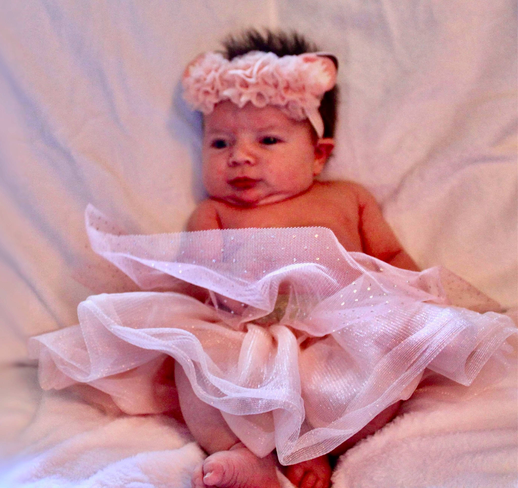 Alexandria is registered to the contest to win money with this photo: baby, baby_products, baby_toddler_clothing, bridal_accessory, child, comfort, costume_hat, embellishment, face, fashion_accessory, hair_accessory, happy, headband, headpiece, headwear, linens, peach, person, petal, pink