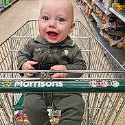 Kas joined the competition — help win amazing prizes! baby, shopping_cart, supermarket, aisle, groceries, child, smiling, clothing, person, retail, floor, socks, seat, metal, shopping, store, happy, indoor, people, cart