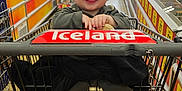 Kas is registered to the contest to win money with this photo: baby, shopping_cart, grocery_store, smiling, child, aisle, products, price_sign, floor, clothing, socks, person, supermarket, food, shopping, baby_face, happy, indoor, retail, store