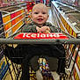 Kas is registered to the contest to win money with this photo: baby, shopping_cart, grocery_store, smiling, child, aisle, products, price_sign, floor, clothing, socks, person, supermarket, food, shopping, baby_face, happy, indoor, retail, store