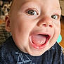 Kas is registered to the contest to win money with this photo: baby, child, smiling, happy, face, closeup, eyes, tongue, mouth, clothing, sailboat_pattern, indoor, dog, pet, blurred_background, cute, infant, portrait, person, joyful