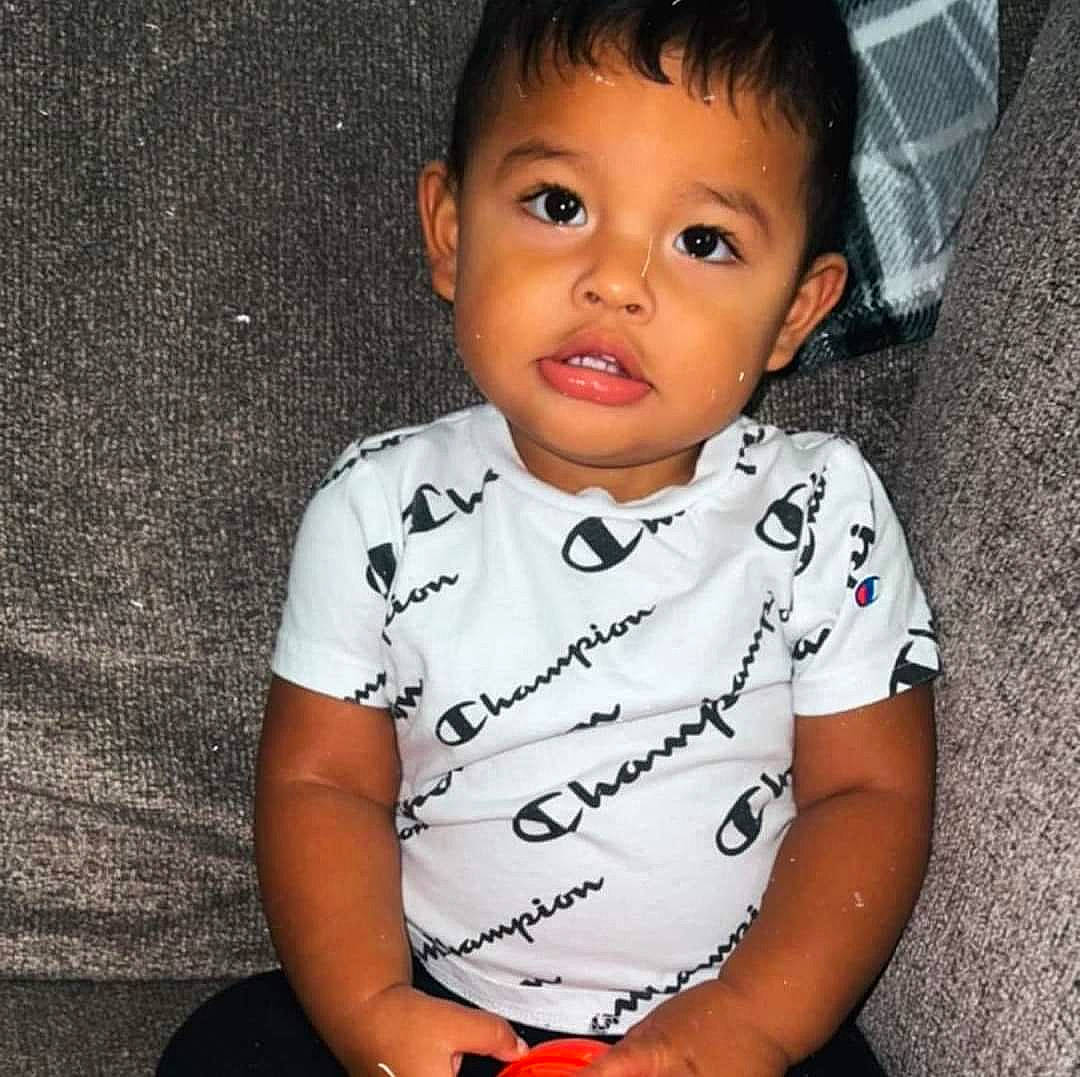 Braylon is registered to the contest to win money with this photo: baby, baby_toddler_clothing, cheek, child, collar, elbow, eyelash, flash_photography, grass, happy, head, nose, pattern, person, portrait_photography, sitting, skin, sleeve, smile, t_shirt