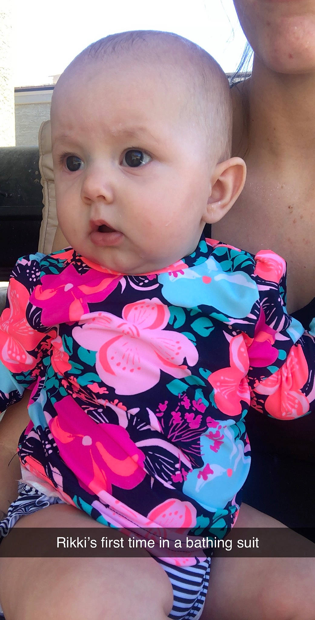 Rikki is registered to the contest to win money with this photo: baby, baby_products, baby_toddler_clothing, cheek, child, dress, face, head, lip, neck, outerwear, pattern, person, pink, plant, product, skin, sleeve, surprise, toddler