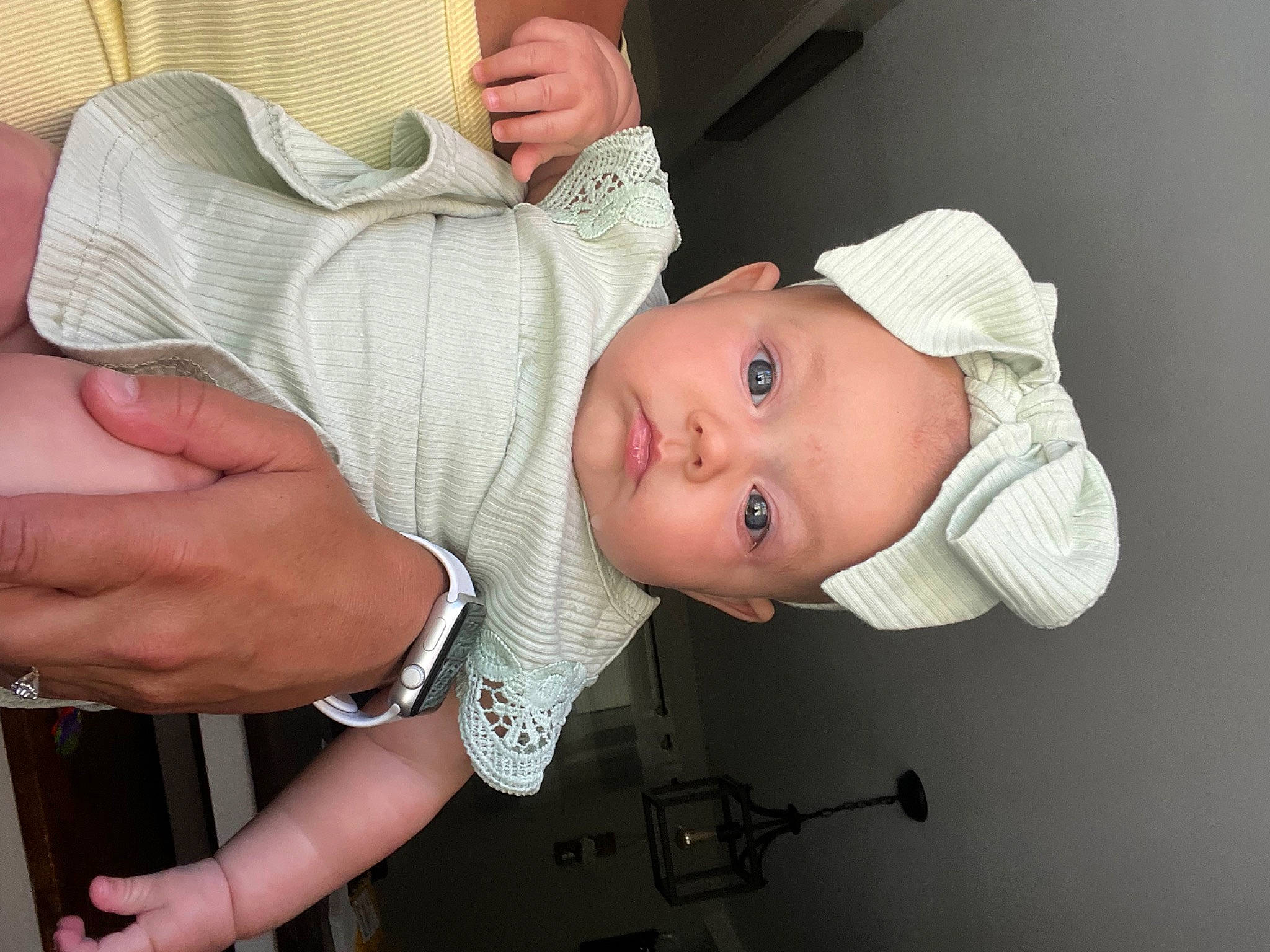 Nina is registered to the contest to win money with this photo: baby, baby_toddler_clothing, cheek, comfort, ear, eye, eyebrow, eyelash, finger, gesture, hand, hat, headgear, headwear, mouth, neck, nose, person, skin, sleeve