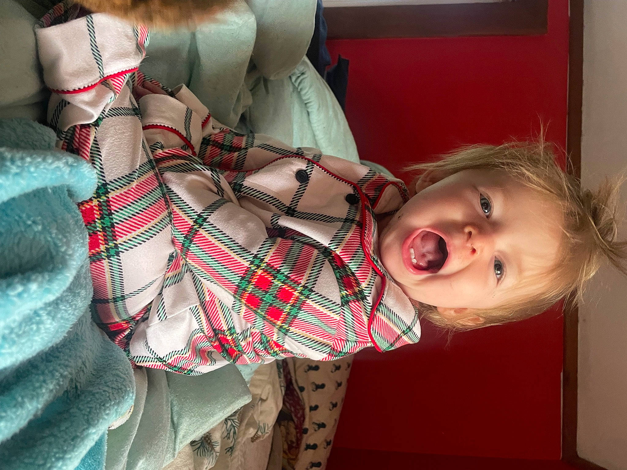 Octavia is registered to the contest to win money with this photo: arm, chest, child, comfort, design, dress, elbow, hand, human_body, leg, mouth, pattern, person, plaid, room, skin, tartan, textile, thigh, toddler