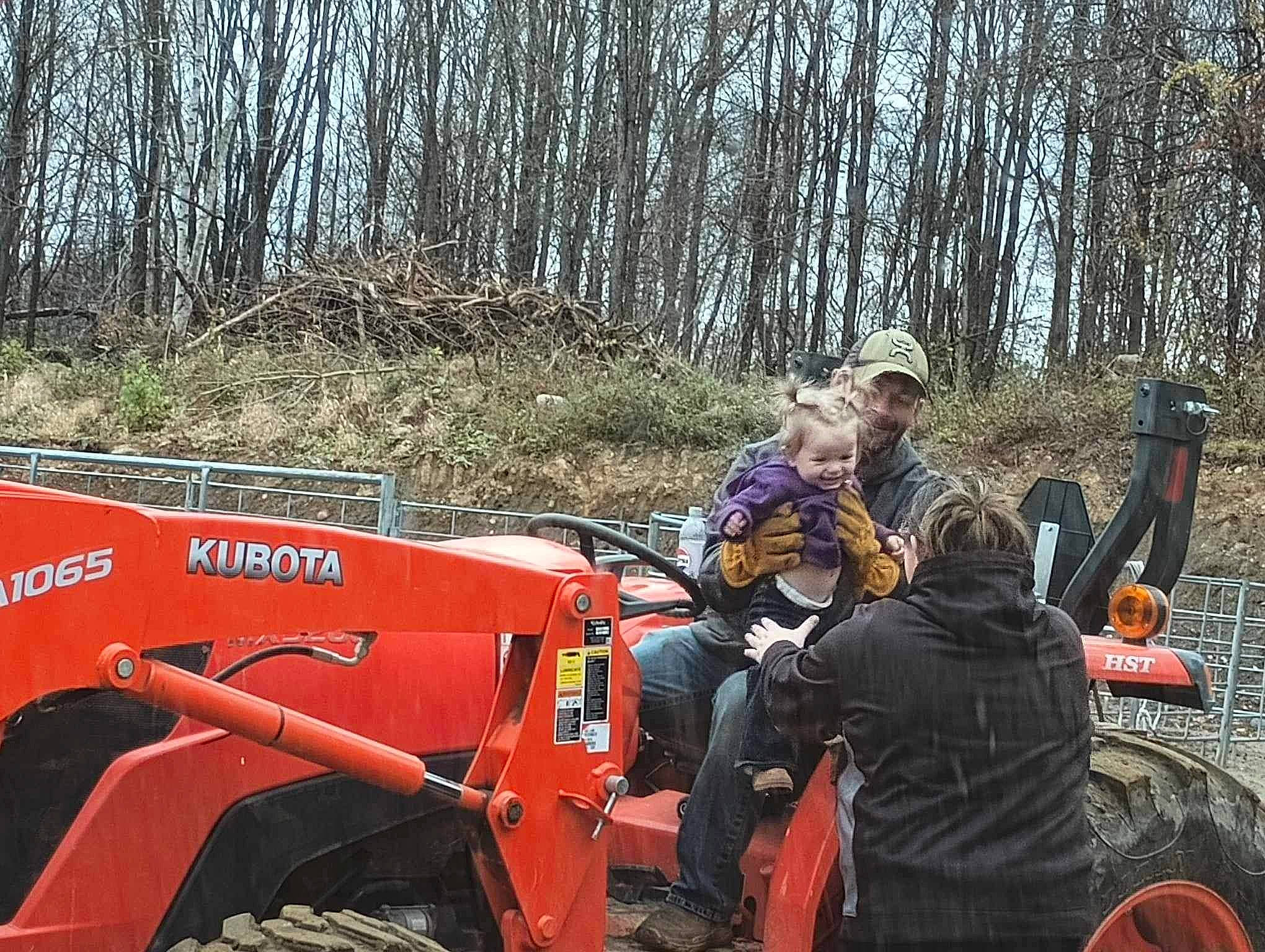 Octavia is registered to the contest to win money with this photo: agricultural_machinery, auto_part, automotive_design, automotive_exterior, automotive_tire, automotive_wheel_system, fender, grass, headwear, joy, machine, mode_of_transport, motor_vehicle, person, plant, rural_area, soil, tire, tractor, tread