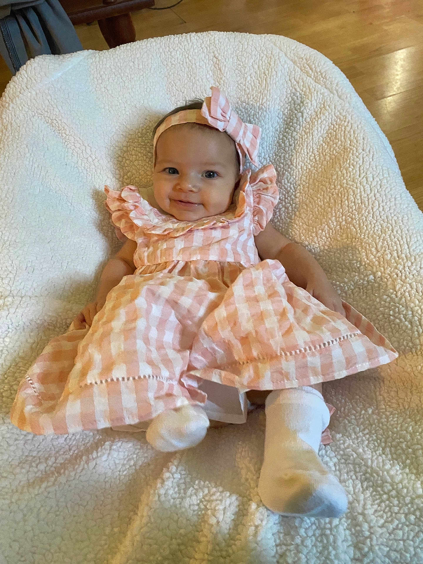 Haisley joined the competition — help win amazing prizes! baby, infant, smile, headband, dress, pink, white, sock, blanket, soft, cozy, indoor, floor, wooden_floor, furniture, child, cute, portrait, happy, lying_down