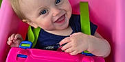 Sylvia is registered to the contest to win money with this photo: baby, blue_eyes, child, clothing, daylight, fun, green_background, happy, infant, outdoor, person, pink_swing, play, playground, seatbelt, short_hair, smiling, summer, swing, toy