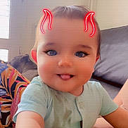 Maïlone participe au concours pour gagner de l'argent avec cette photo : baby, child, clothing, couch, cute, devil_horns, eyelashes, face, filter, indoor, infant, light, person, pillow, playful, portrait, short_sleeves, smile, tongue_out, window