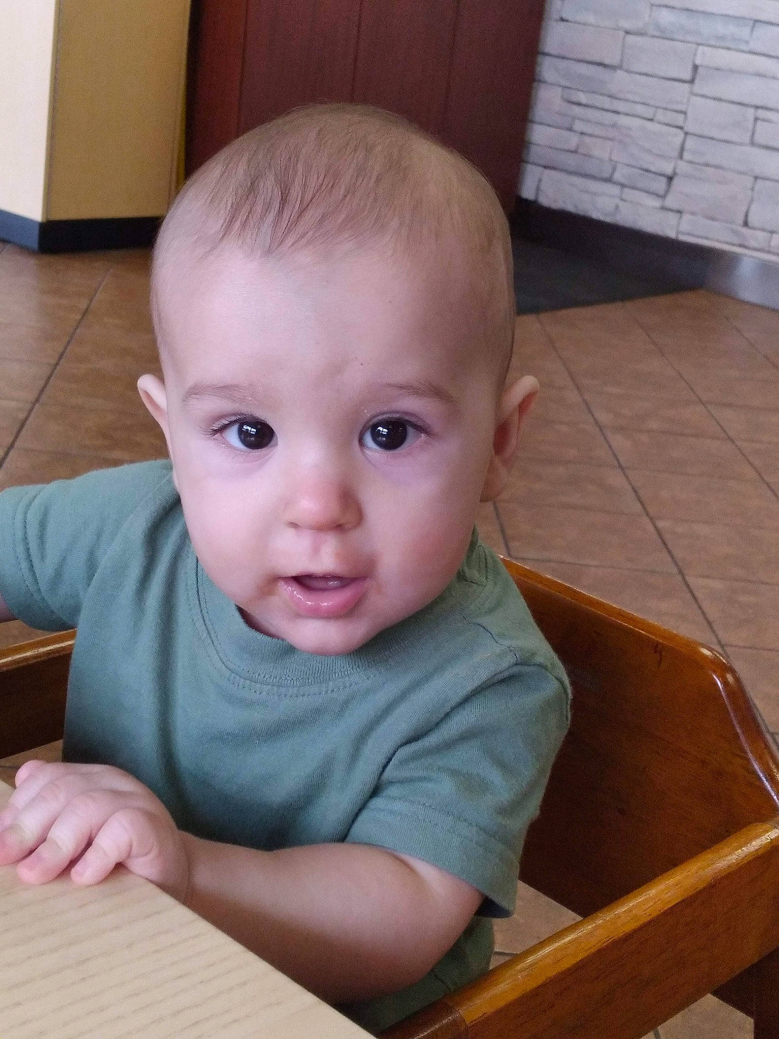 Sabastian is registered to the contest to win money with this photo: baby, baby_toddler_clothing, chair, cheek, child, chin, eyelash, flooring, fun, hardwood, iris, nose, person, sitting, skin, table, thumb, toddler, varnish, wood