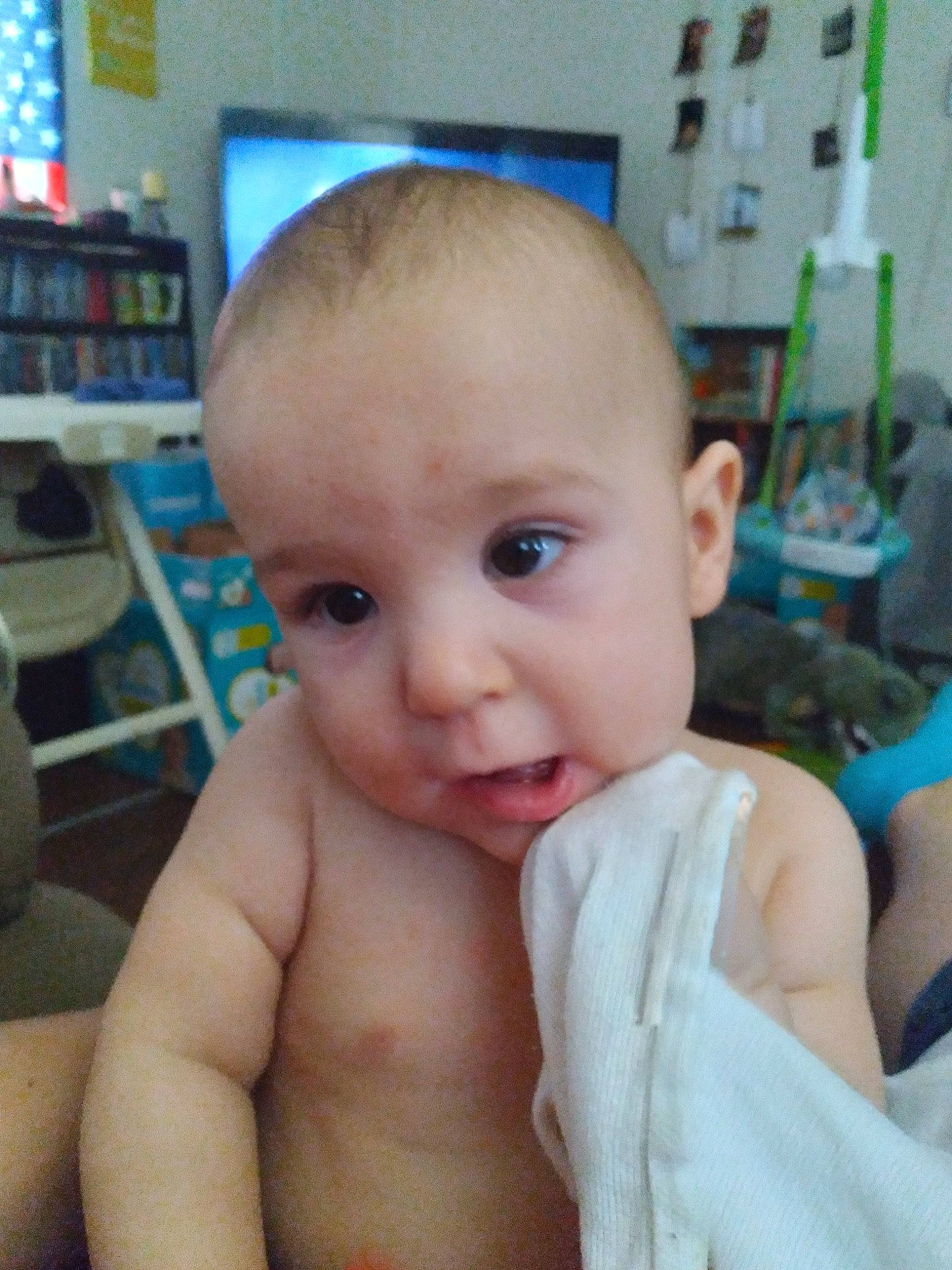 Sabastian is registered to the contest to win money with this photo: baby, cheek, chin, ear, eyebrow, eyelash, finger, forehead, gesture, iris, jaw, mouth, neck, nose, organ, person, shelf, skin, smile, thumb