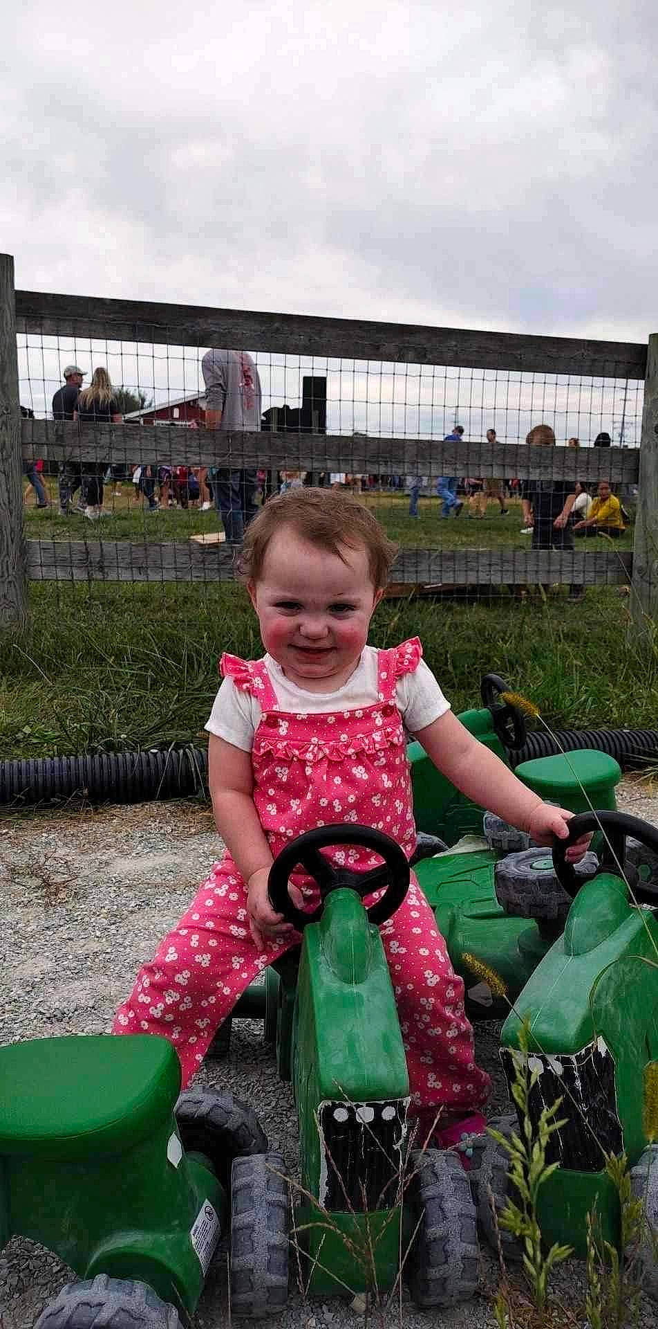 Rylee joined the competition — help win amazing prizes! automotive_tire, child, city, cloud, fun, grass, happy, joy, leisure, magenta, motor_vehicle, person, plant, recreation, riding_toy, sitting, sky, smile, tire, toddler