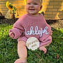 baby, child, infant, pink_sweater, white_bow, grass, outdoor, sunlight, flower, yellow_flower, brick_wall, smiling, happy, cute, seven_months, headband, barefoot, portrait, nature, sitting