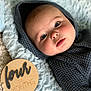 baby, infant, four_months, blanket, knitwear, blue_eyes, face, portrait, cozy, cute, wooden_plaque, milestone, soft_texture, laying_down, indoors, child, newborn, head, expression, warm