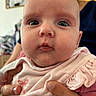 Judith a rejoint le concours — aidez-le/la à gagner de superbes lots ! baby, infant, child, face, eyes, hands, pink_clothing, ruffles, close_up, portrait, indoor, person, skin, expression, holding, cute, young_child, soft_lighting, background_blur, human