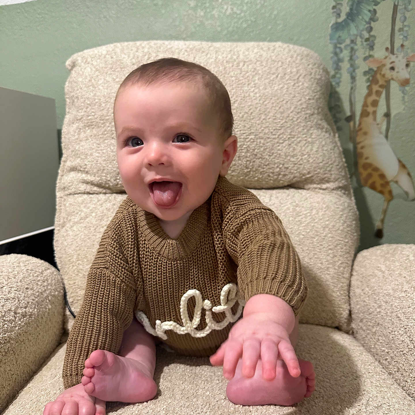 Carlito Torres joined the competition — help win amazing prizes! armchair, baby, beige, brown_clothing, child, cute, giraffe, happy, home, indoor, infant, person, playful, plush_texture, portrait, seated, smiling, sweater, tongue_out, wall_decal