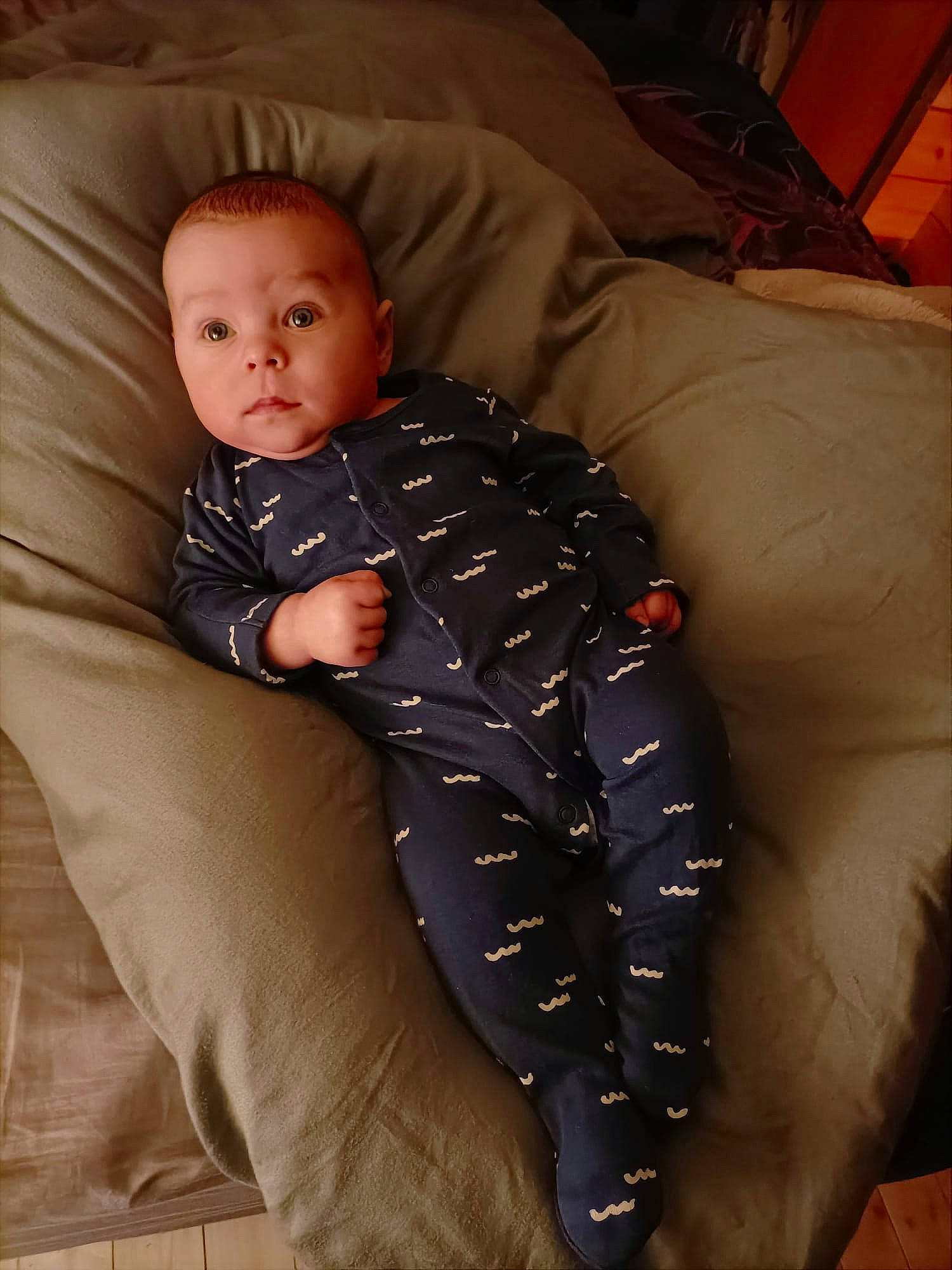 Jonah is registered to the contest to win money with this photo: baby, baby_toddler_clothing, child, collar, comfort, couch, flooring, formal_wear, head, lap, linens, pattern, person, room, sitting, sleeve, suit, textile, toddler, wood
