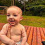 baby, smiling, outdoor, wooden_deck, greenery, forest, child, diaper, happy, person, nature, cute, skin, hand, holding, infant, daylight, portrait, cheerful, young
