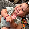 Aziel joined the competition — help win amazing prizes! baby, child, infant, smiling, happy, portrait, indoor, couch, cushion, seated, reclining, short_sleeves, bracelet, toys, playroom, home, close_up, face, hands, joyful