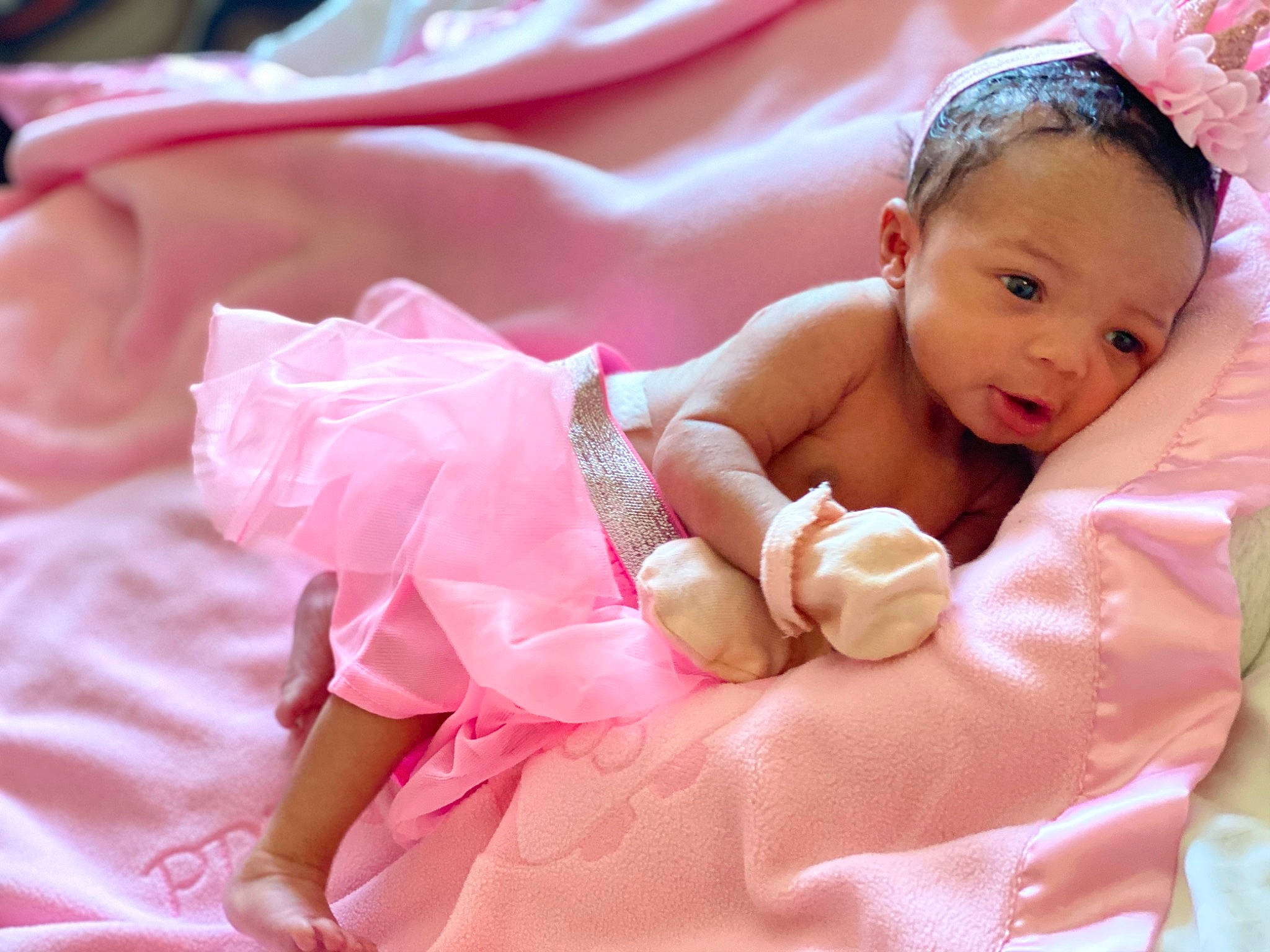 Royale is registered to the contest to win money with this photo: baby, baby_products, baby_toddler_clothing, cheek, child, hair_accessory, person, pink, skin, smile, toddler