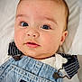 baby, infant, face, blue_eyes, denim_overalls, clothing, white_shirt, close_up, cute, portrait, child, skin, eyes, baby_clothes, soft, newborn, person, head, expression, laying