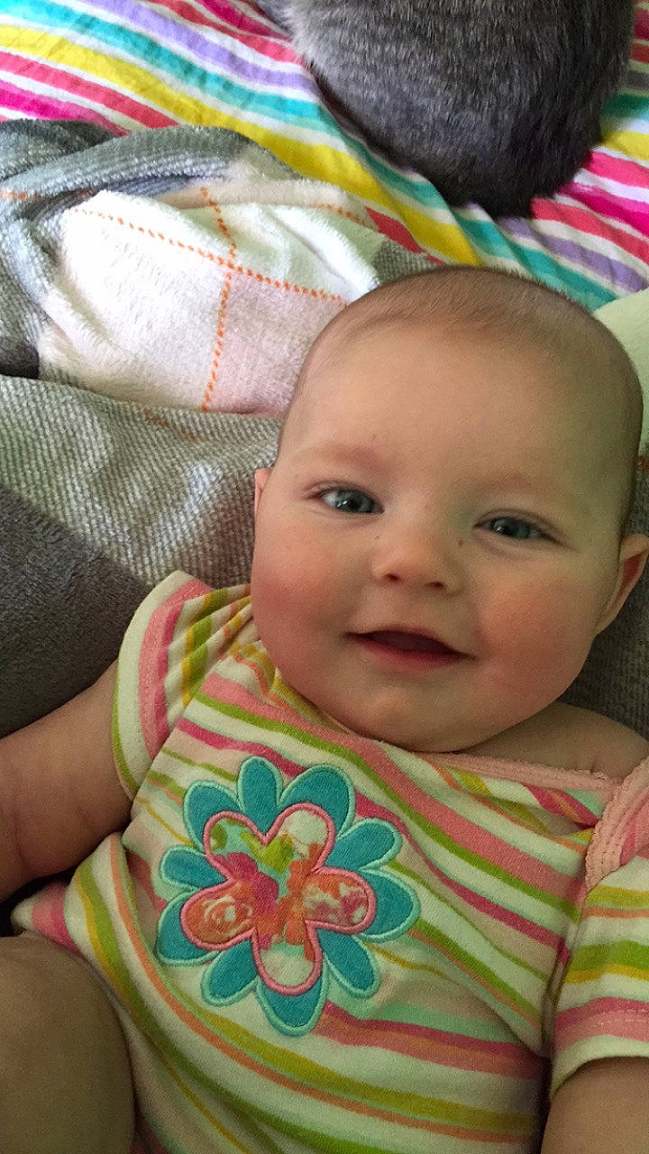 Celina is registered to the contest to win money with this photo: baby, baby_toddler_clothing, cheek, chin, eye, eyebrow, face, green, happy, head, iris, joy, lip, mouth, nose, person, pink, product, skin, smile