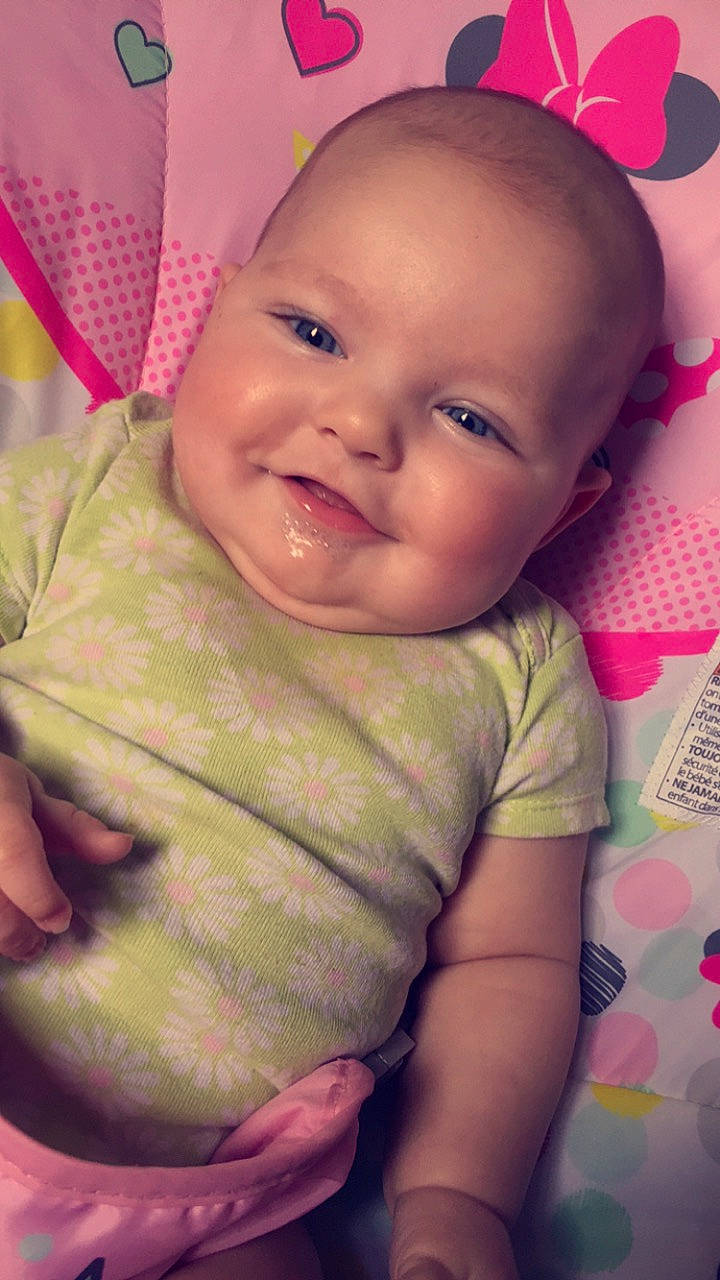 Celina is registered to the contest to win money with this photo: baby, baby_toddler_clothing, cheek, chin, ear, eye, eyebrow, face, facial_expression, happy, iris, joy, lip, mouth, nose, organ, person, pink, product, skin