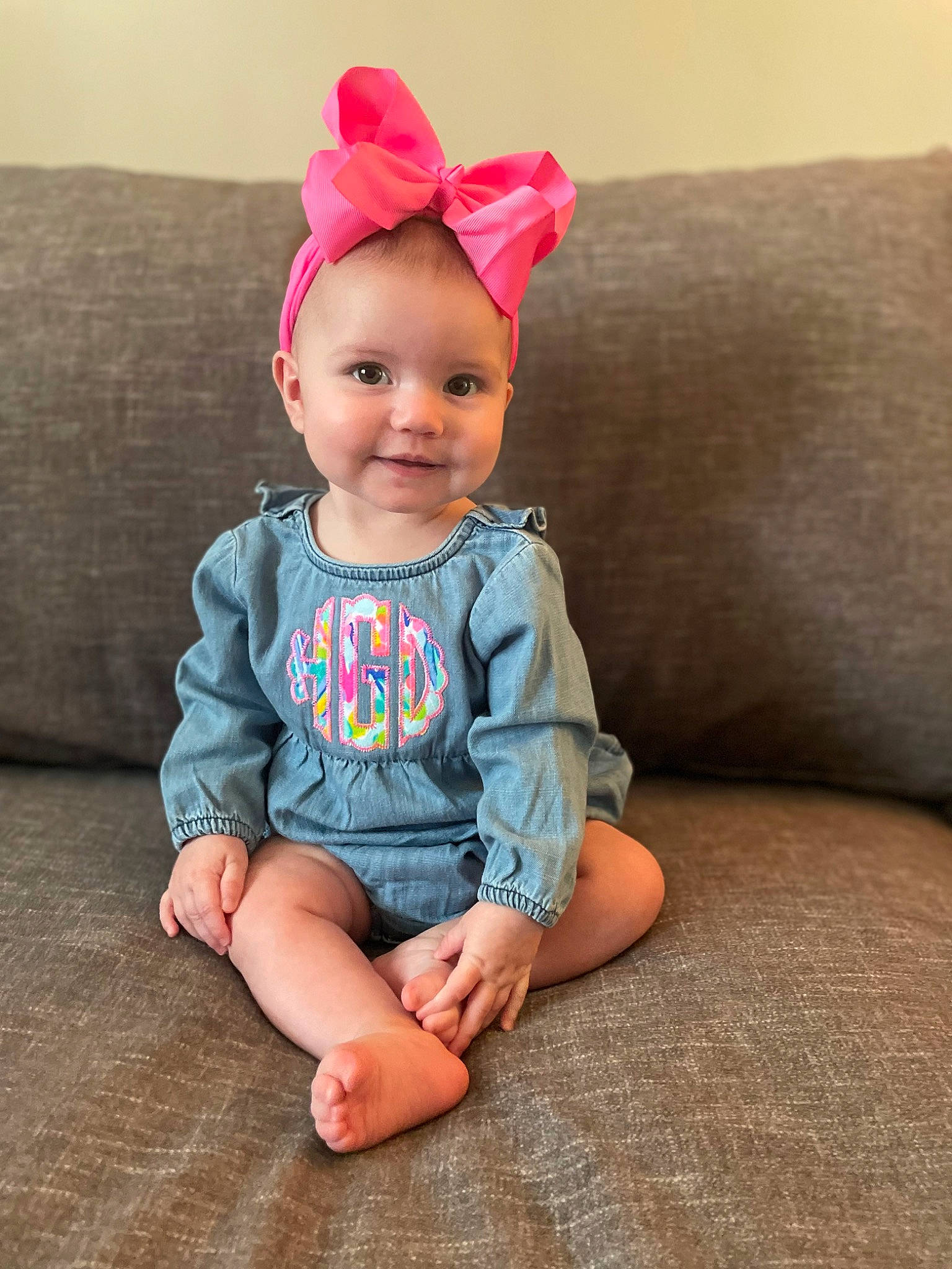Hensley is registered to the contest to win money with this photo: baby_toddler_clothing, cap, child, clothing, costume_hat, couch, eye, glasses, happy, hat, head, headgear, human_body, joy, magenta, party_hat, person, pink, skin, sleeve