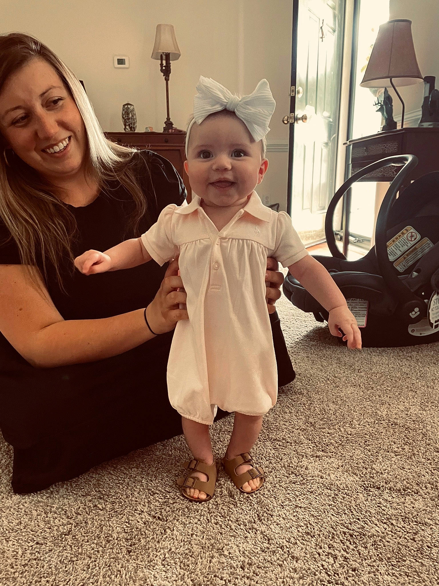 Hensley is registered to the contest to win money with this photo: arm, baby, baby_toddler_clothing, child, face, fashion, finger, flash_photography, flooring, fun, gesture, happy, interaction, joy, person, shoulder, skin, sleeve, smile, standing