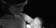 Braxton is registered to the contest to win money with this photo: arms, baby, black_and_white, calm, caring, closeup, dark_background, face, holding, infant, love, mother, newborn, peaceful, person, portrait, sleeping, soft_light, tender, woman