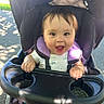 Braxton is registered to the contest to win money with this photo: baby, stroller, child, smiling, outdoor, sunlight, happy, infant, seat, tray, hands, clothing, person, portrait, daylight, nature, young, cute, head, babywearing