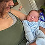 Braxton is registered to the contest to win money with this photo: baby, box, child, clothing, decor, face, furniture, hand, holding, home, indoor, nail_polish, pajamas, person, portrait, sleeping, smile, tattoo, wall, woman
