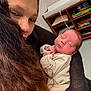 Braxton is registered to the contest to win money with this photo: woman, baby, newborn, sleeping, holding, indoor, love, care, family, portrait, face, hair, clothing, sleeve, furniture, pillow, shelf, toy, blanket, peaceful