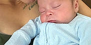 Braxton is registered to the contest to win money with this photo: adult, baby, casual, closeup, clothing, comfort, cozy, cuddling, face, hand, indoor, infant, light_blue, love, person, portrait, skin, sleeping, toddler, warmth