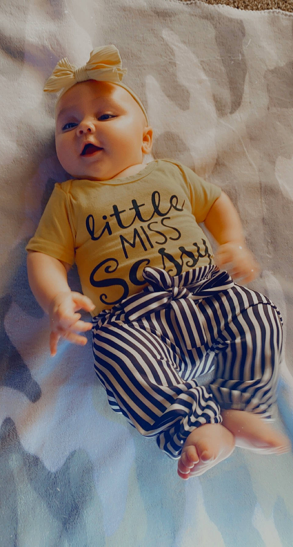 Alainah is registered to the contest to win money with this photo: arm, baby, baby_toddler_clothing, comfort, eye, face, facial_expression, finger, hairstyle, hand, happy, head, human, leg, nose, orange, organ, person, skin, sleeve