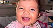 Vera joined the competition — help win amazing prizes! baby, smiling, child, indoor, pink_shirt, kitten_print, happy, face, cute, person, infant, clothing, hand, blanket, bedroom, home, toddler, portrait, joyful, expression
