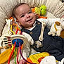 baby, smiling, toy, giraffe_toy, pacifier, plush_toy, baby_nest, infant, colorful, cute, child, white_shirt, blue_overall, hand, face, happy, lying_down, soft_texture, bright, indoor